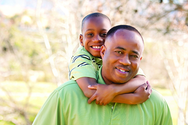 African American Man and Child Having Fun in the Park. African American Man and Child Having Fun in the Park.